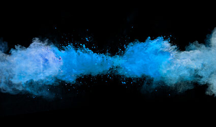 blue dust dispersing in a black background