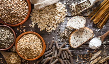 Grains, seeds, bread and pasta on a wooden table