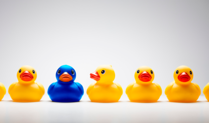 Several yellow rubber ducks in a row with one blue duck in the middle