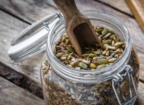 A mason jar filled with assorted seeds